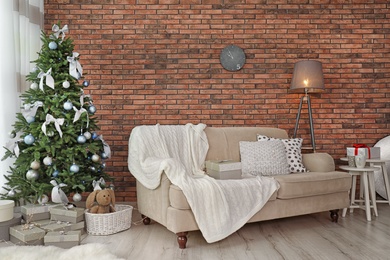 Decorated Christmas tree in stylish living room interior