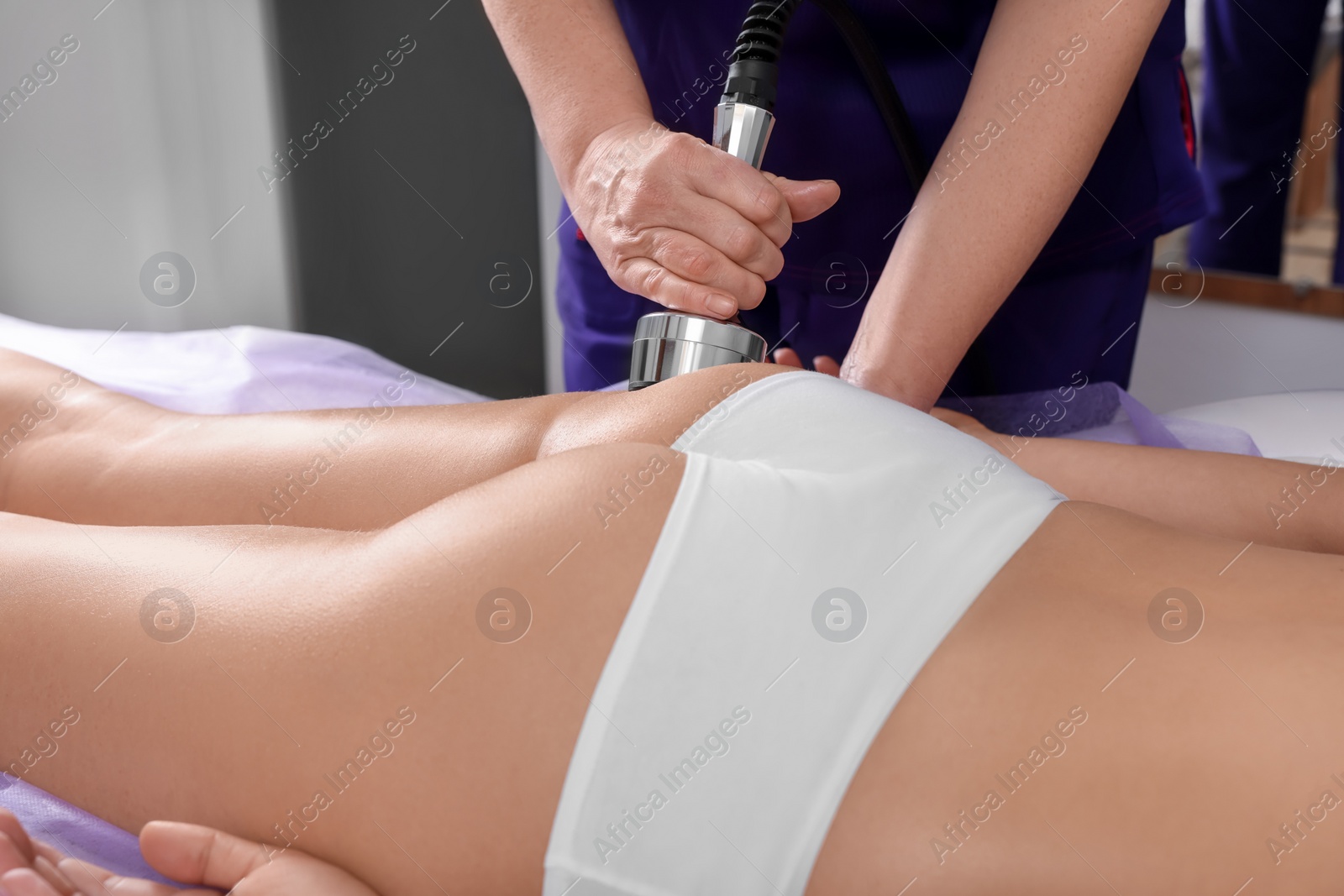 Photo of Woman undergoing radio frequency lifting procedure in beauty salon, closeup