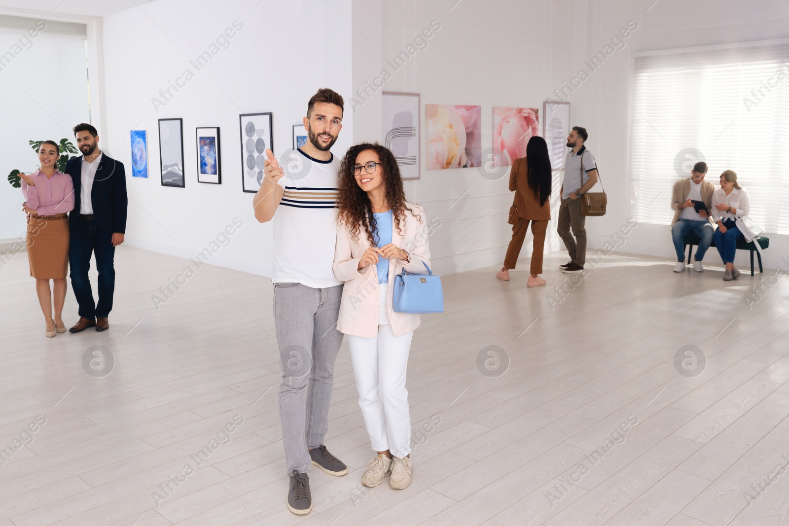 Photo of Happy couple at exhibition in art gallery