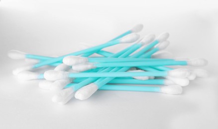 Photo of Heap of clean cotton buds on white background