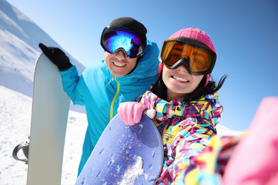 Photo of Couple taking selfie on hill. Winter vacation