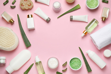 Flat lay composition with aloe vera and cosmetic products on pink background. Space for text