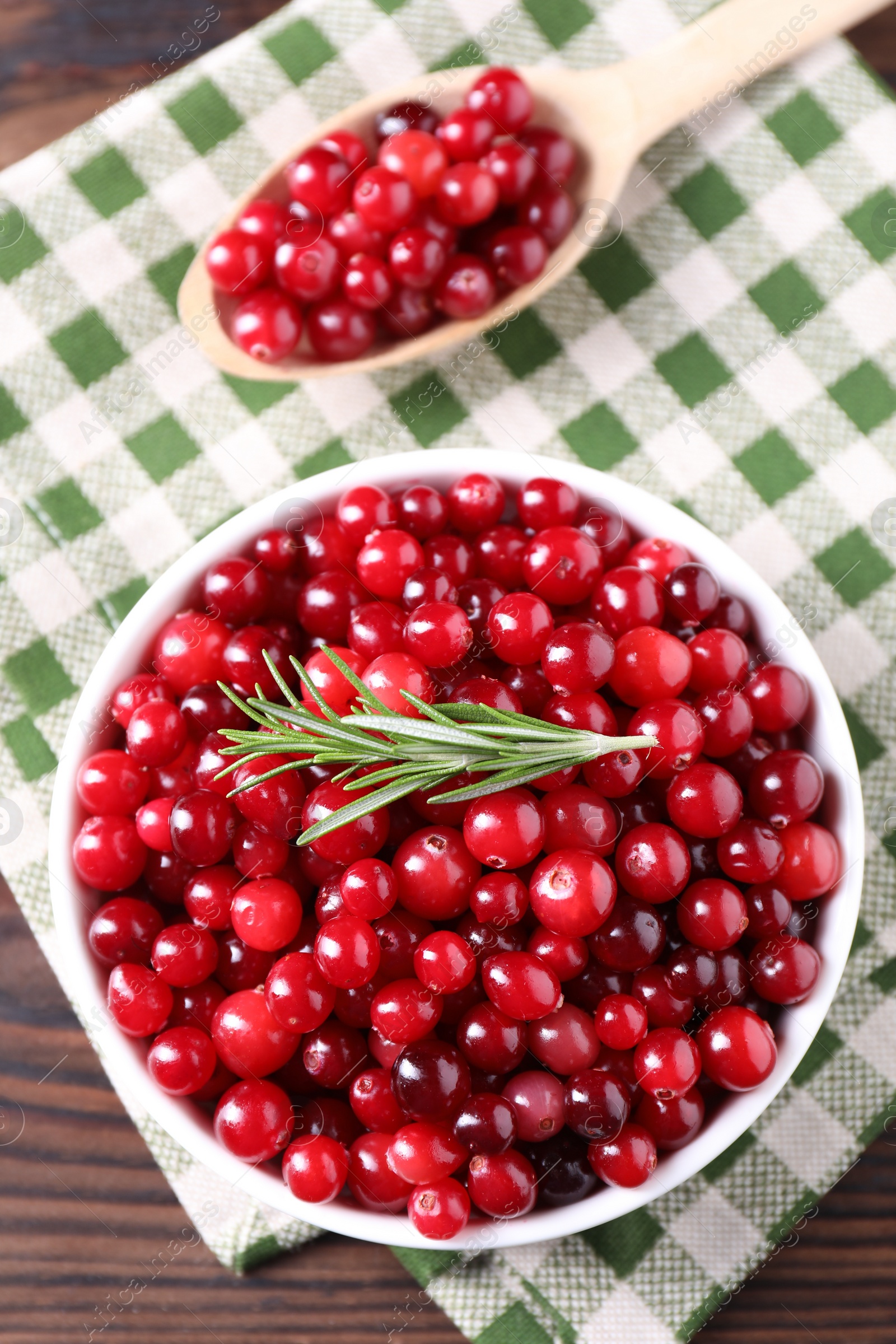 Photo of Fresh ripe cranberries on wooden table, flat lay