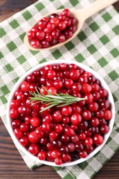 Fresh ripe cranberries on wooden table, flat lay