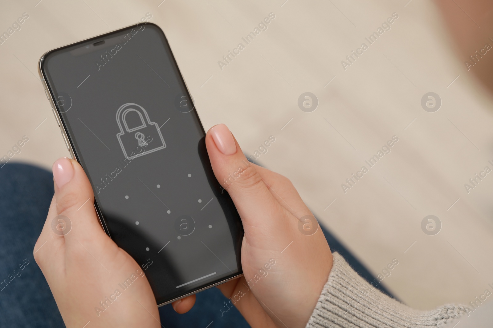 Photo of Woman holding smartphone with blocked screen indoors, closeup. Space for text