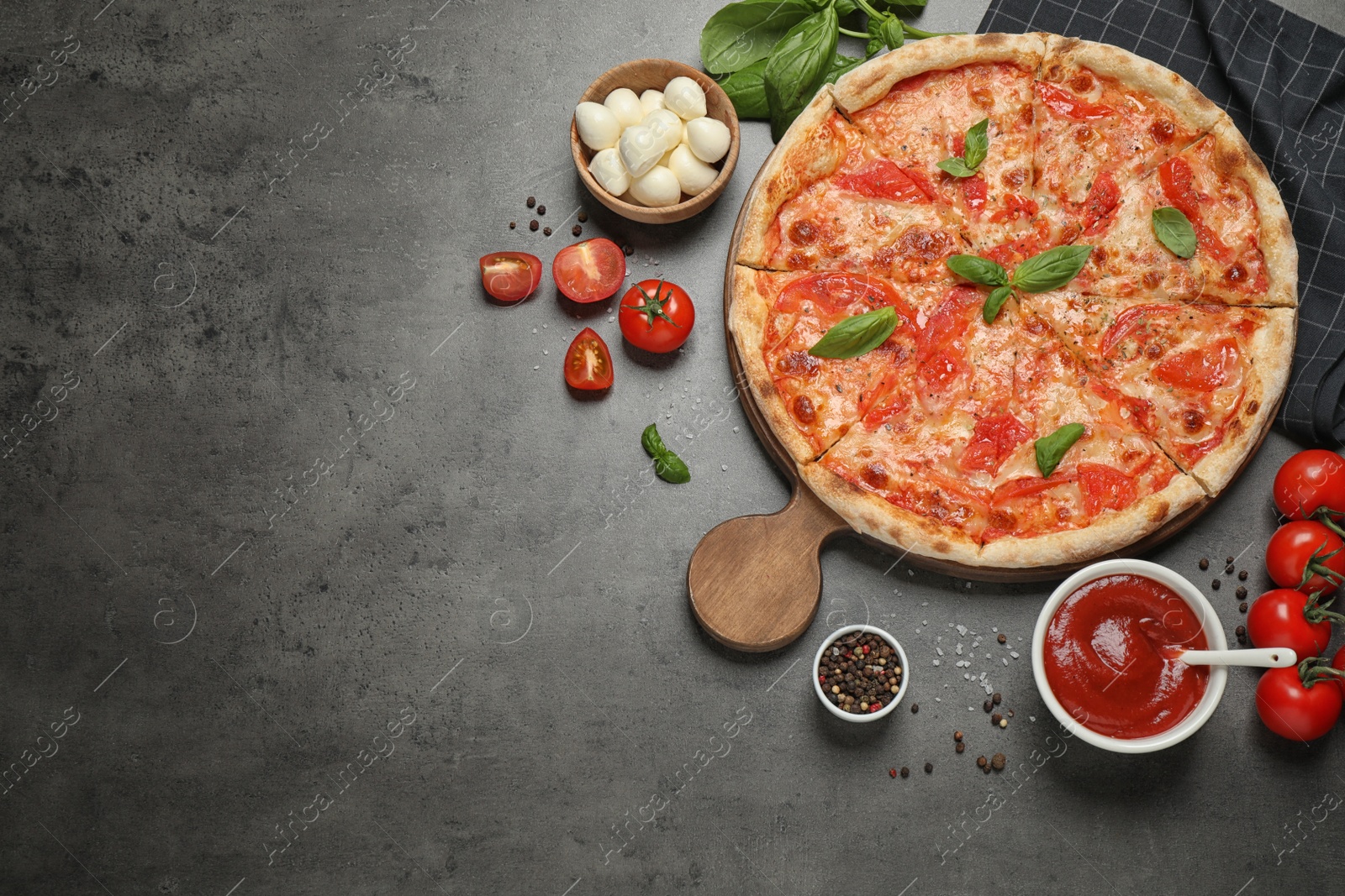 Photo of Delicious pizza Margherita and ingredients on grey table, flat lay. Space for text