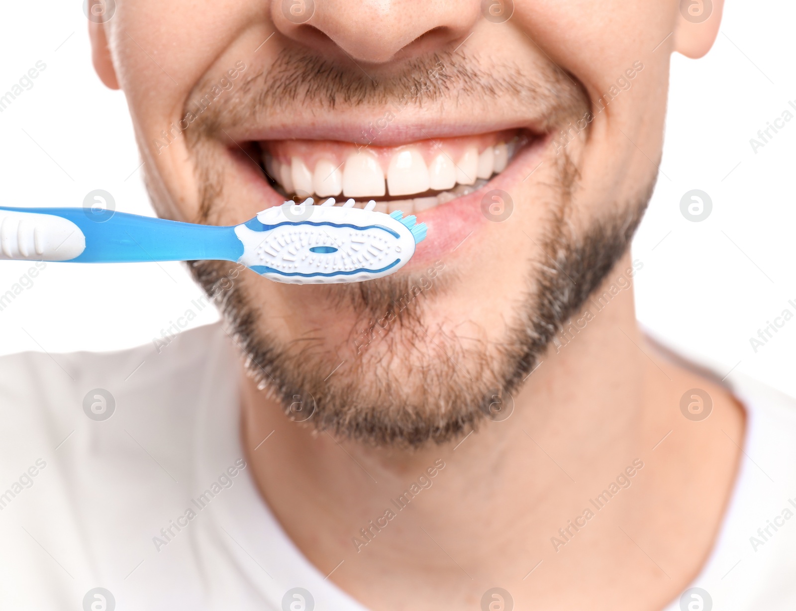 Photo of Young man brushing his teeth on white background