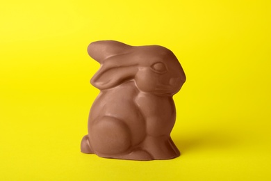 Photo of Chocolate bunny on yellow background. Easter celebration