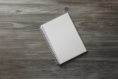 Photo of Blank paper brochure on wooden table, top view. Mockup for design