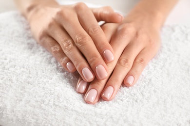 Closeup view of beautiful female hands on towel. Spa treatment