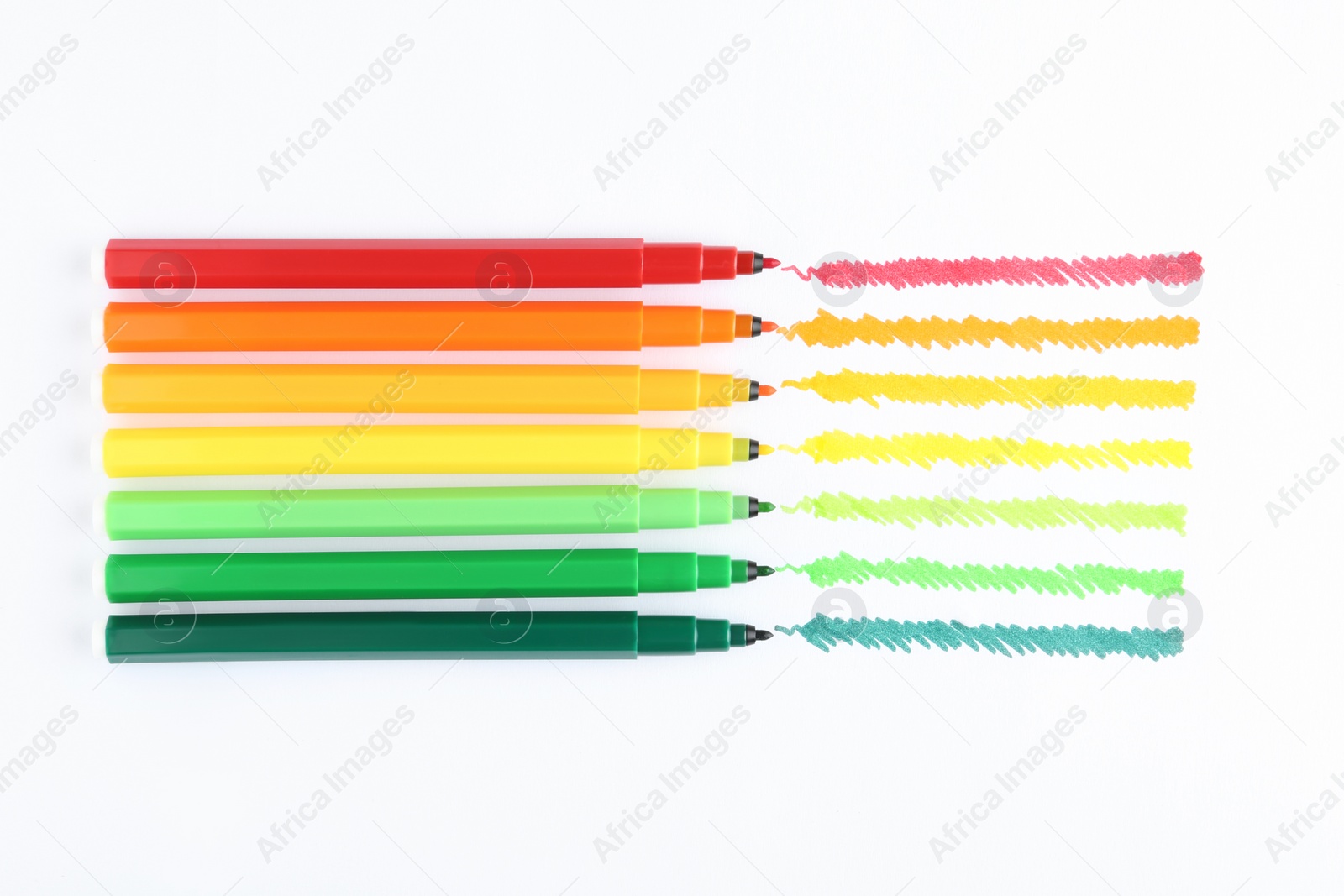 Photo of Flat lay composition with colorful markers on white background. Energy efficiency concept