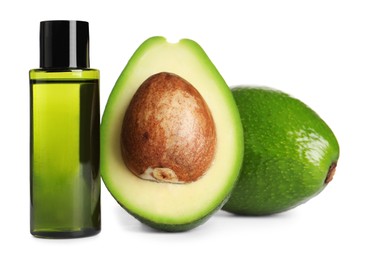 Photo of Bottle of essential oil and avocados on white background