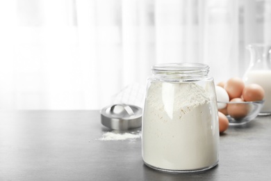 Photo of Jar with flour on kitchen table