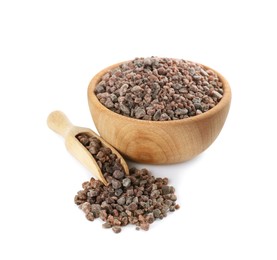 Photo of Wooden bowl and scoop with black salt on white background