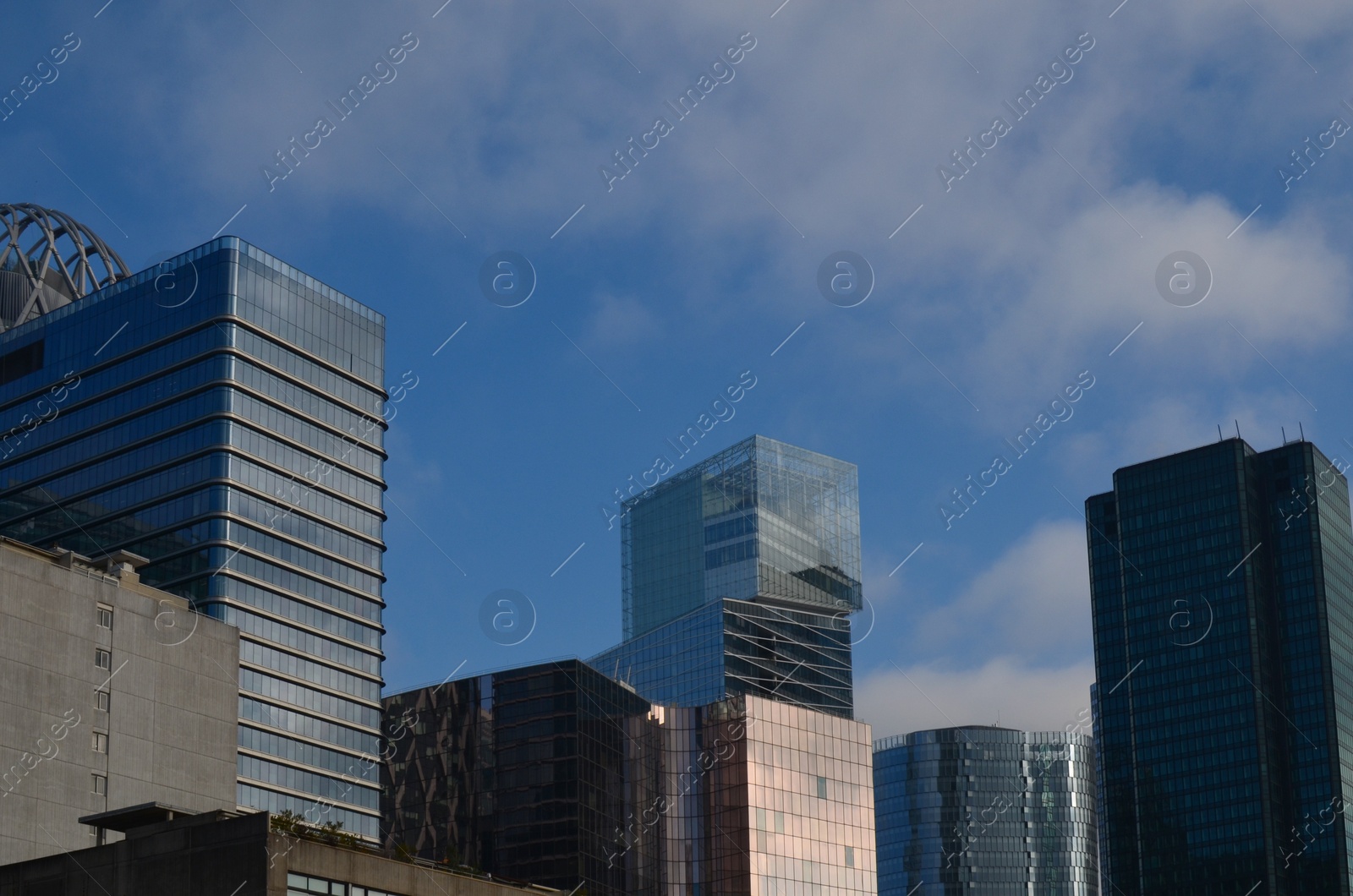 Photo of Exterior of different modern skyscrapers against blue sky