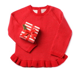 Photo of Red dress and gift box on white background, top view. Christmas baby clothes