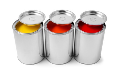 Photo of Cans of orange, yellow and red paints on white background