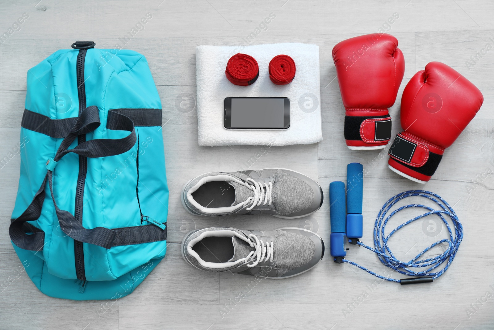 Photo of Flat lay composition with sports bag on wooden floor