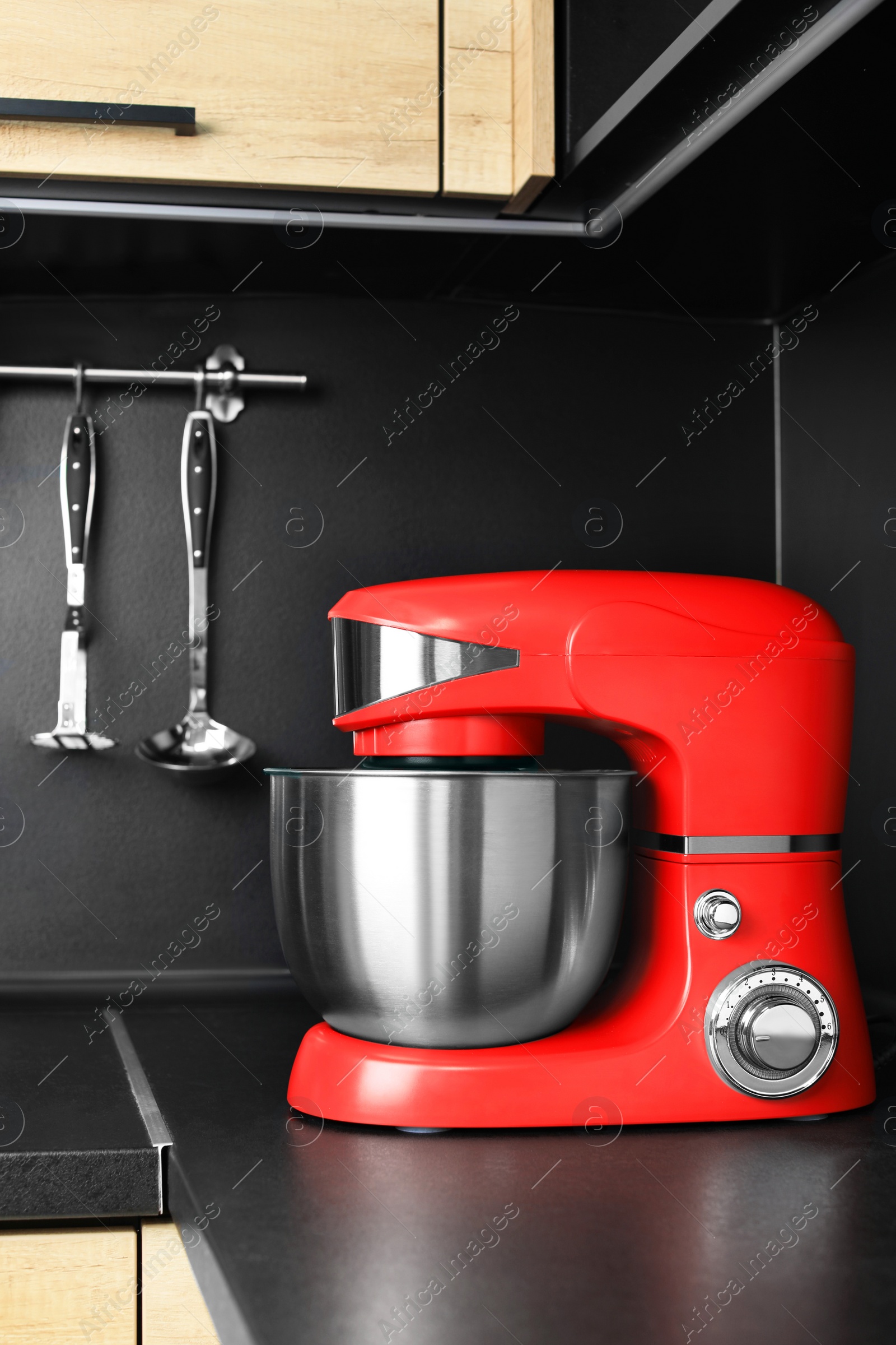 Photo of Modern stand mixer on countertop in kitchen. Home appliance