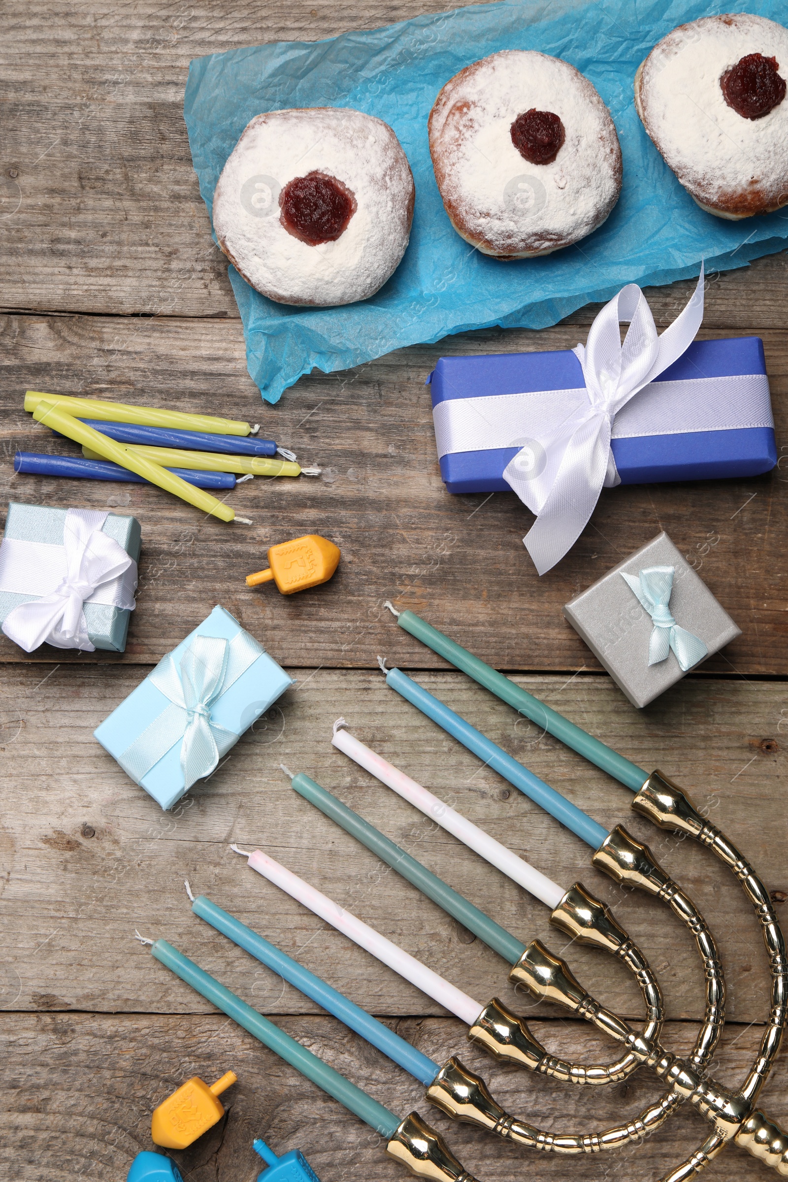 Photo of Flat lay composition with Hanukkah menorah and gift boxes on wooden table