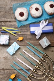Flat lay composition with Hanukkah menorah and gift boxes on wooden table