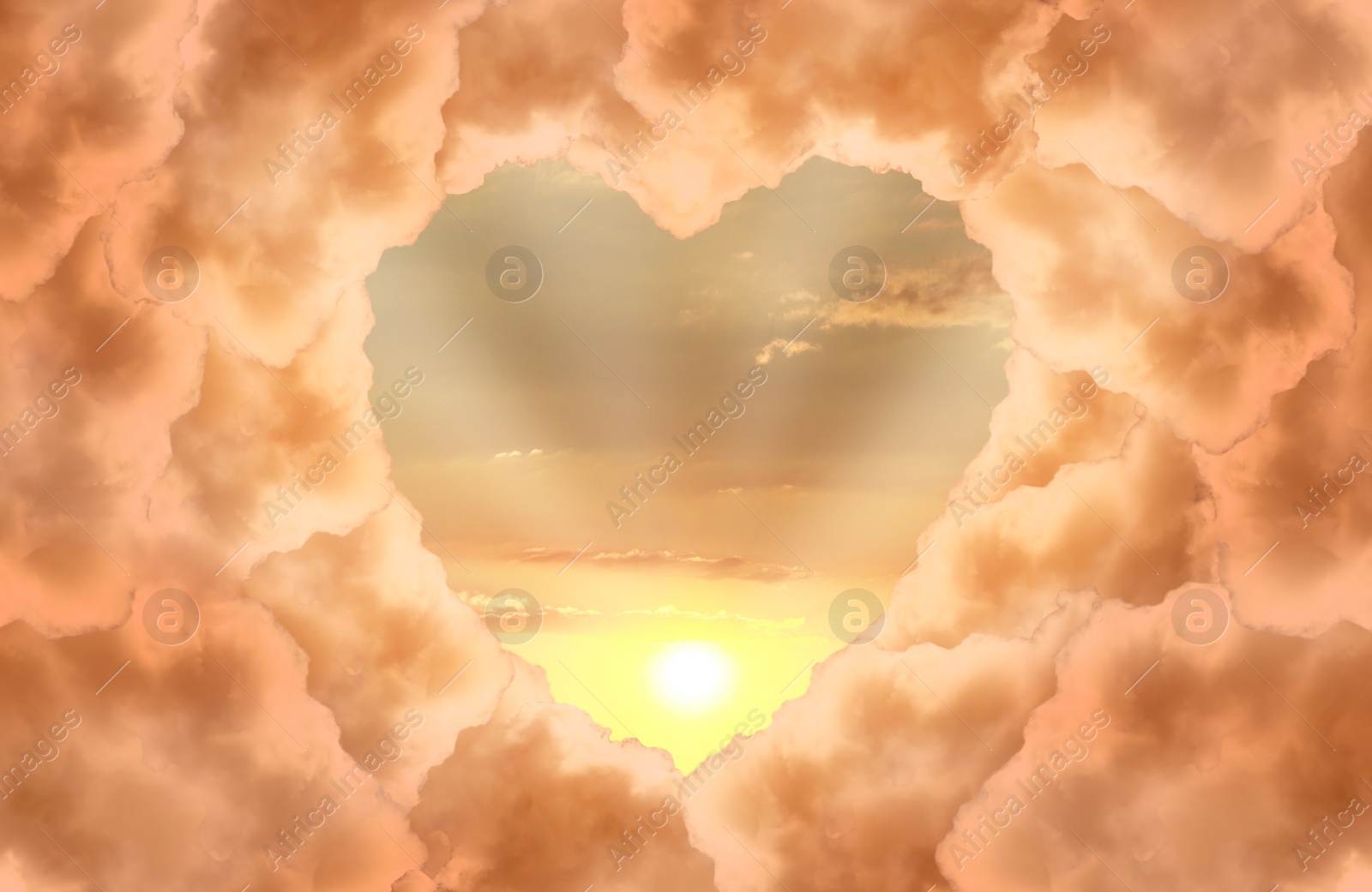 Image of Beautiful sunset, view through heart shaped gap formed from orange clouds on sky