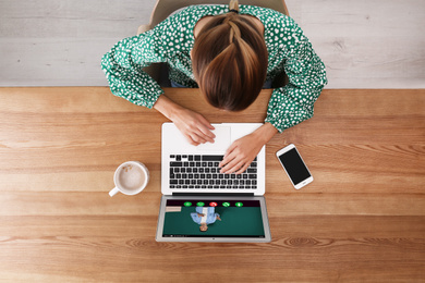 Woman having online video consultation with business trainer at table, top view