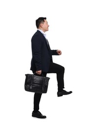 Photo of Businessman in suit with briefcase walking on white background
