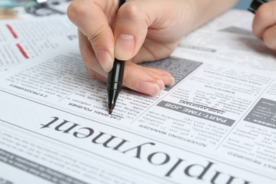 Photo of Woman marking advertisement in newspaper, closeup. Job search concept