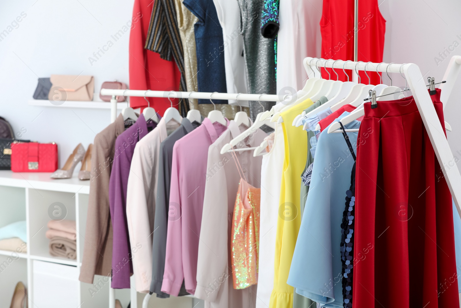 Photo of Racks with different stylish clothes in boutique