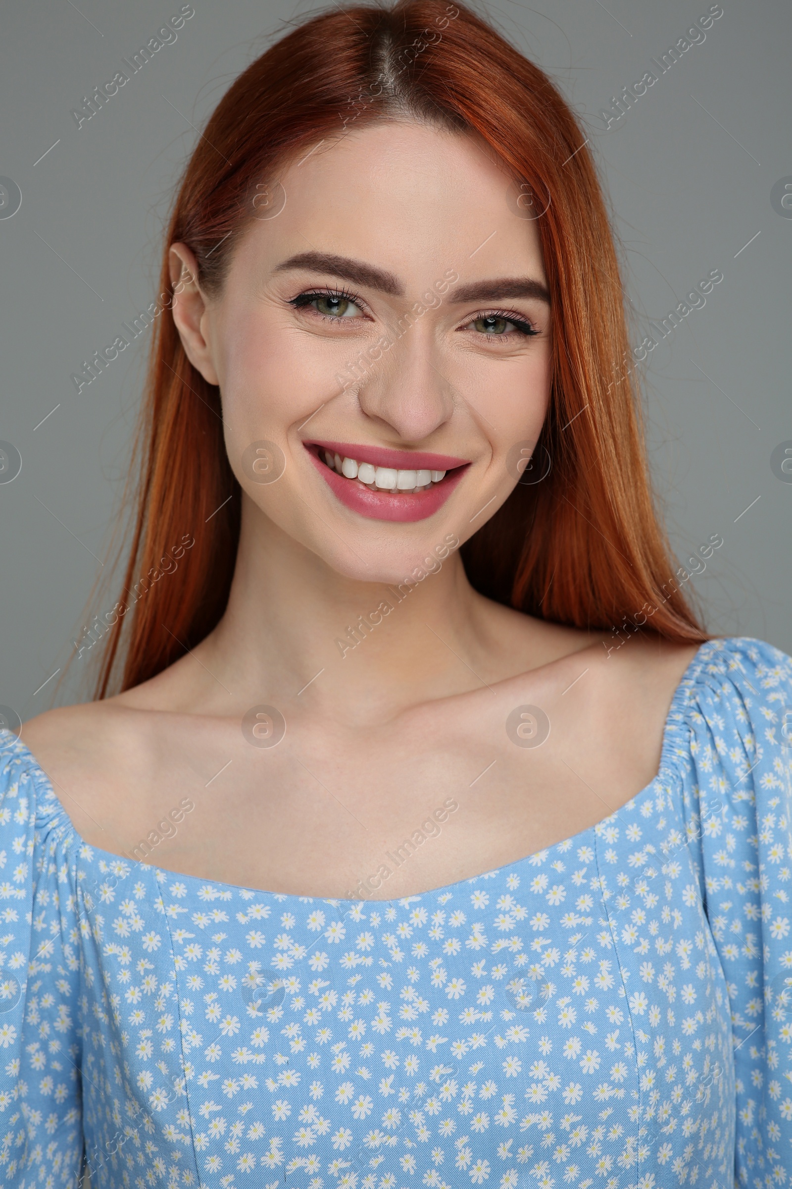 Photo of Portrait of beautiful woman on grey background