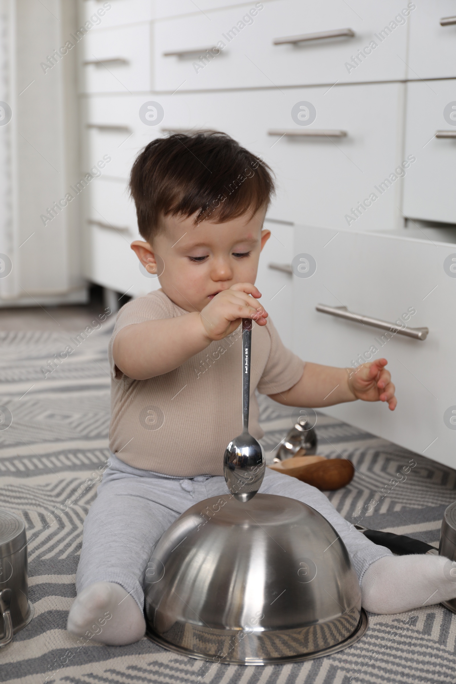 Photo of Cute little boy with cookware at home