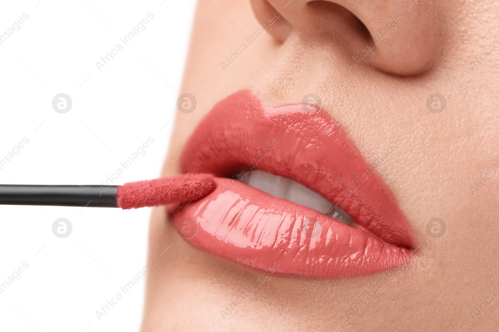 Photo of Woman applying lip gloss on white background, closeup