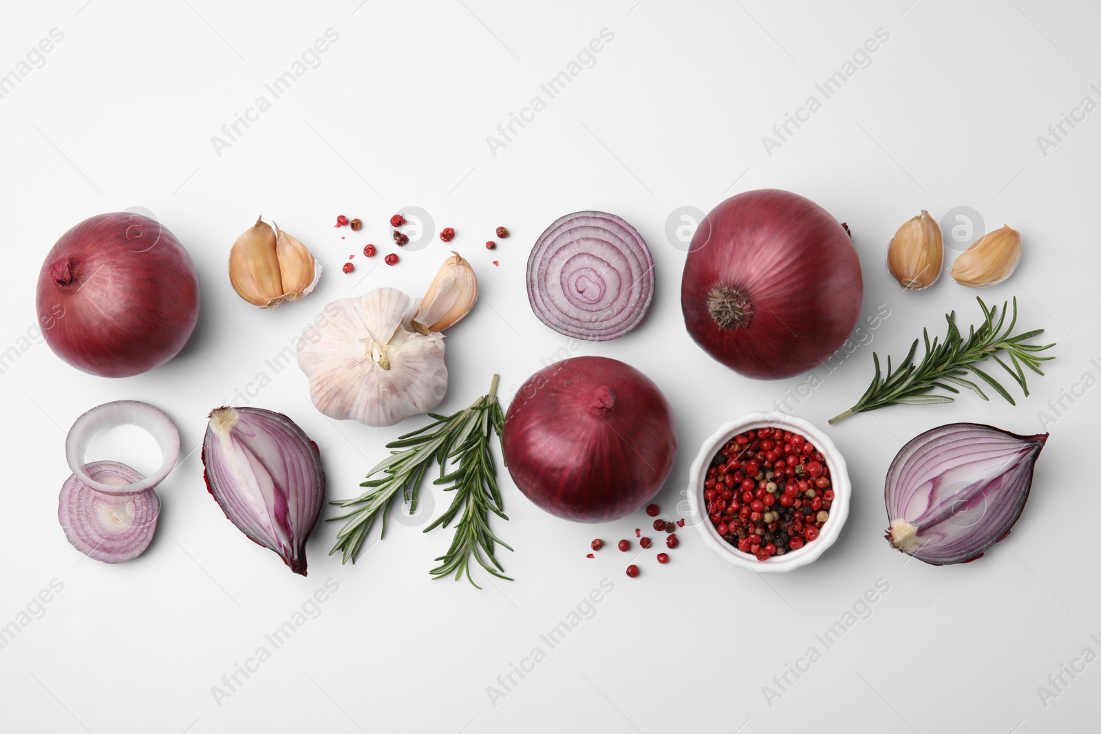 Photo of Fresh red onions, garlic, rosemary and spices on white background, flat lay