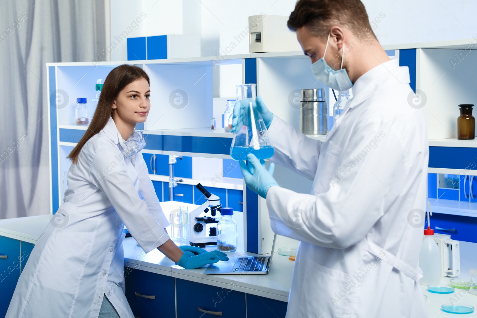 Photo of Young scientists doing research and analysis in chemical laboratory