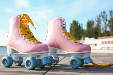 Photo of Stylish vintage roller skates on city embankment