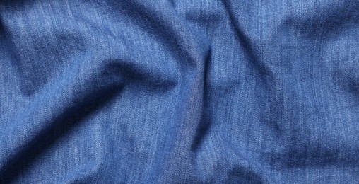 Photo of Texture of blue crumpled fabric as background, top view