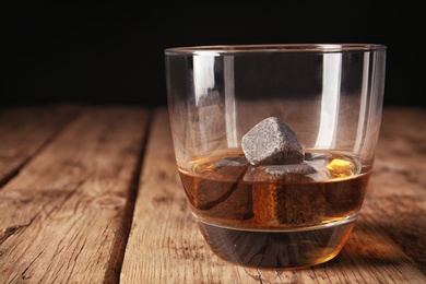 Photo of Glass with liquor and whiskey stones on table