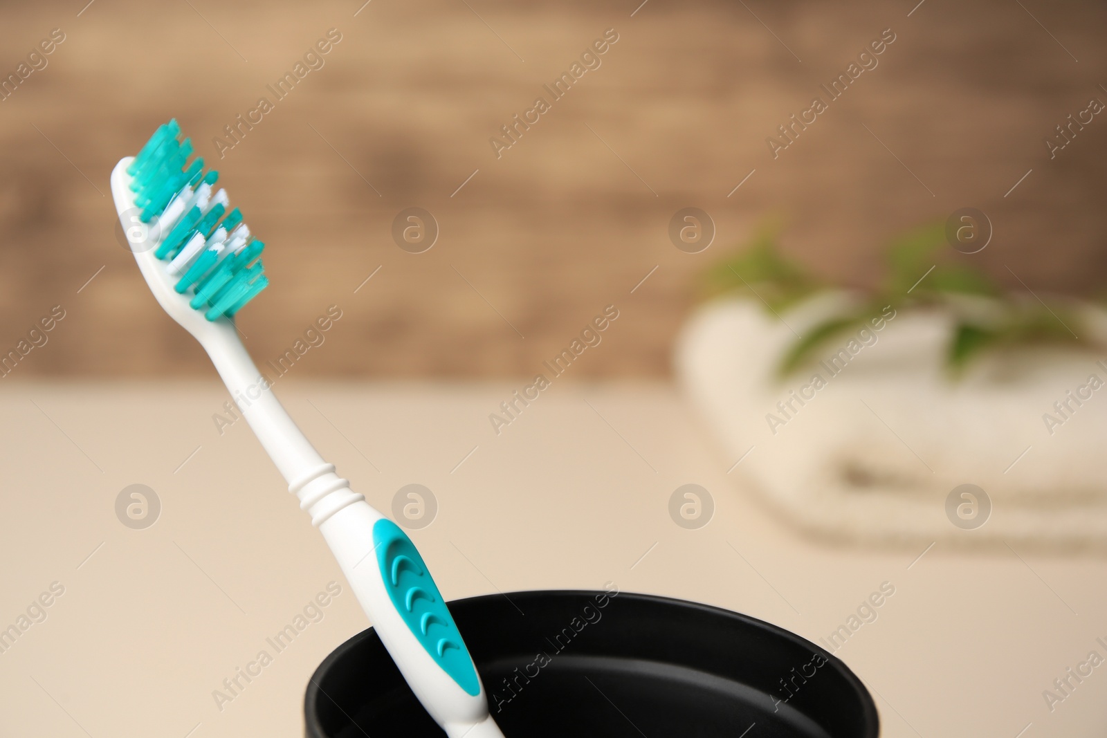 Photo of Toothbrush in holder on blurred background, closeup. Space for text