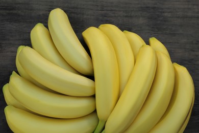 Photo of Ripe yellow bananas on wooden table, flat lay