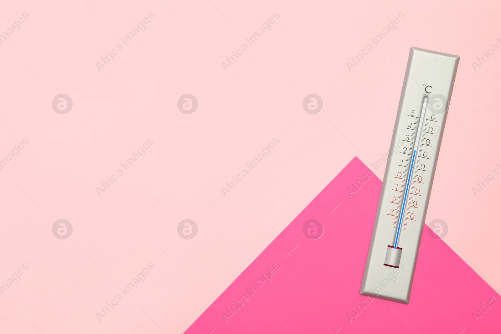 Photo of Weather thermometer on color background, top view. Space for text