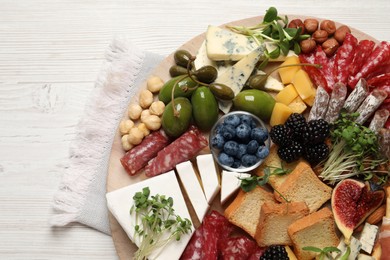 Photo of Different tasty appetizers on white wooden table, top view