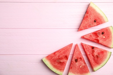 Slices of ripe watermelon on pink wooden table, flat lay. Space for text