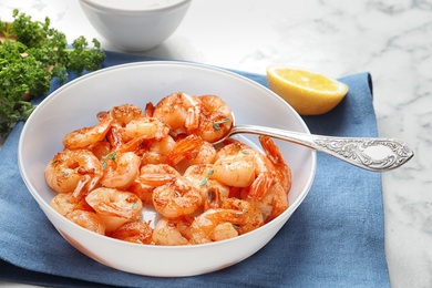 Photo of Bowl with delicious fried shrimps on table