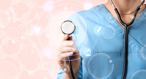 Doctor with stethoscope on pink background, closeup. Medical service