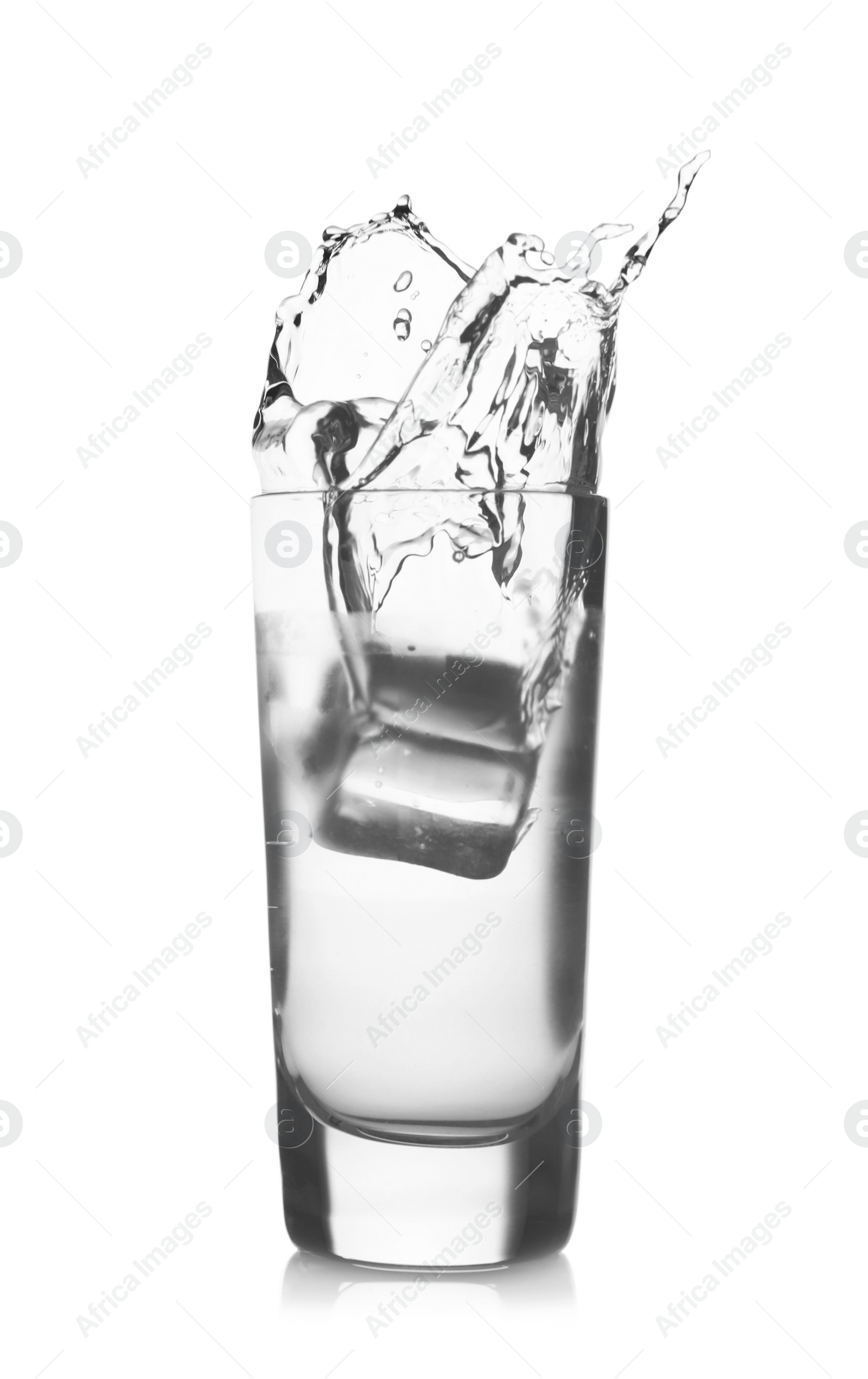 Photo of Ice cube falling into shot glass of vodka on white background