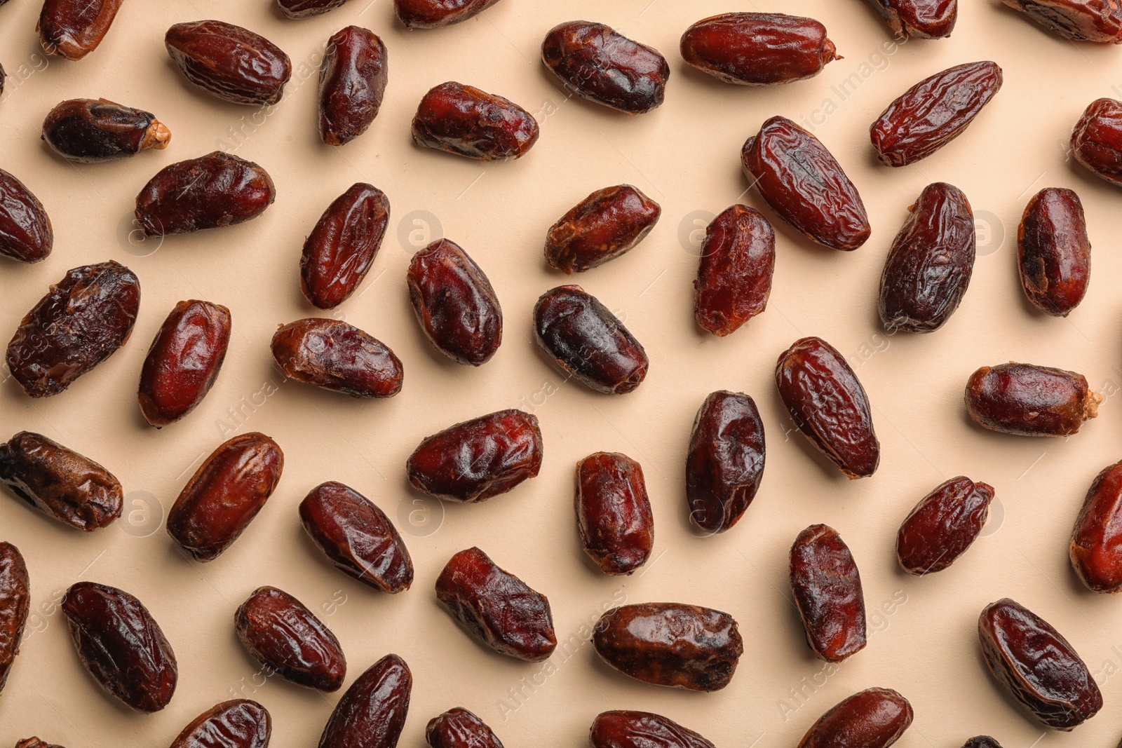 Photo of Sweet dried date fruits on color background, top view