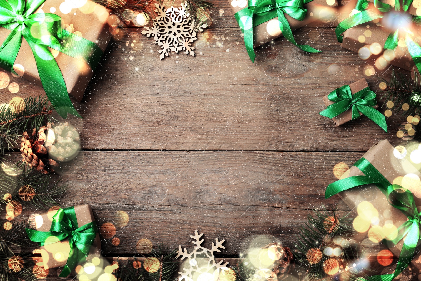 Image of Frame of gift boxes and Christmas decorations on wooden table, flat lay. Space for text