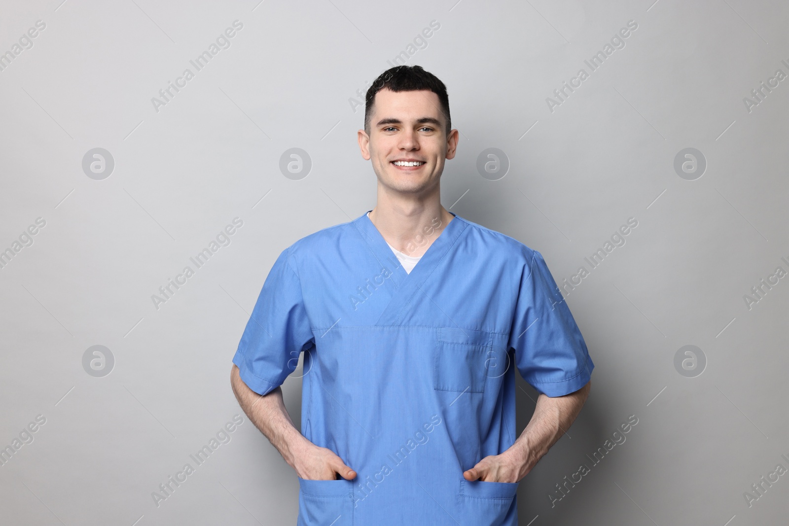 Photo of Portrait of smiling medical assistant on grey background