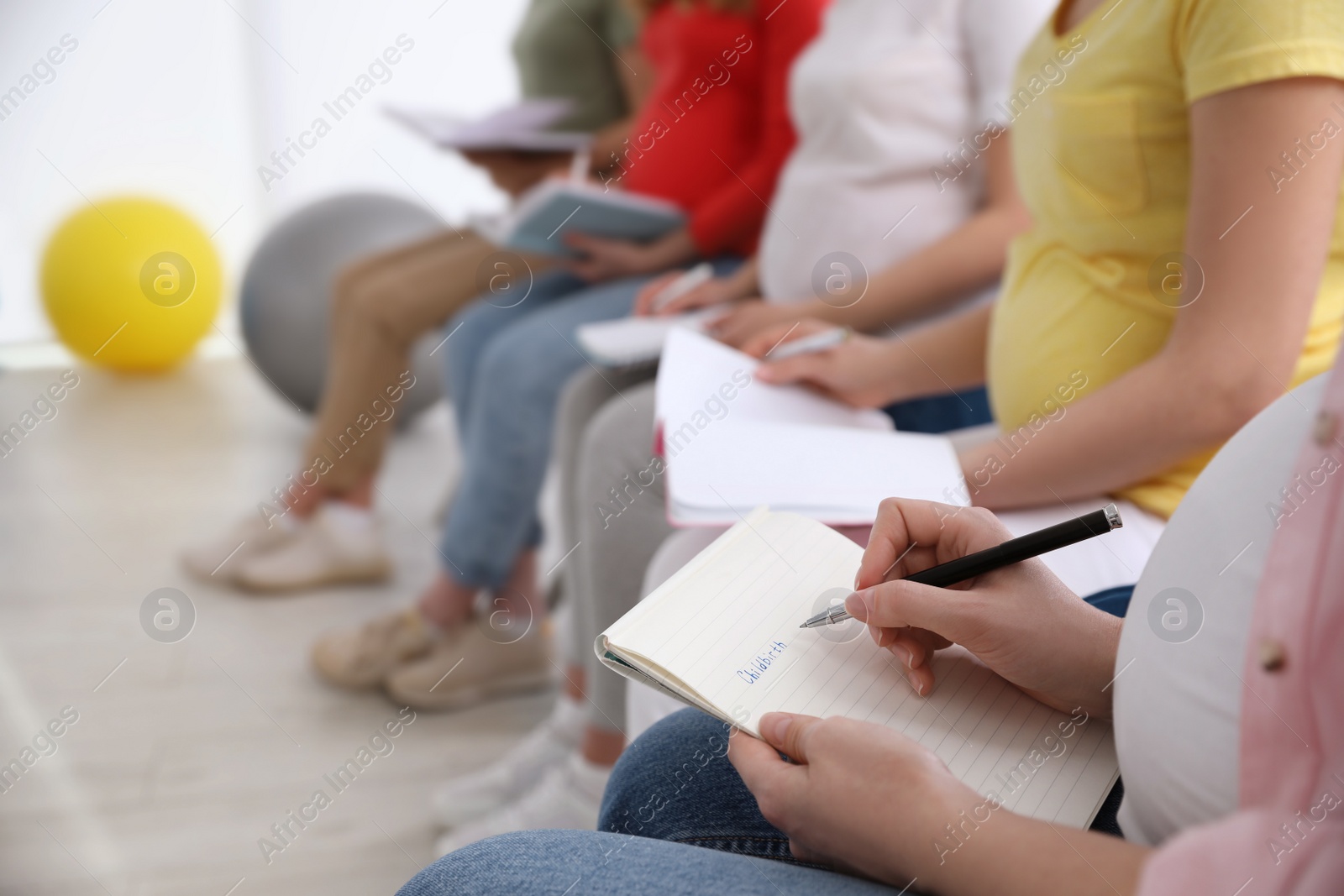 Photo of Group of pregnant women at courses for expectant mothers indoors, closeup